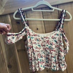 Beautiful floral, baby dollblouse front button details and pom-poms on the strap
